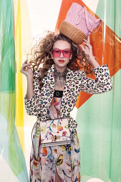 Printed jacket and bag by Giorgio Armani, Miu Picnic bag by by Miu Miu and sunglasses by Stella McCartney Image