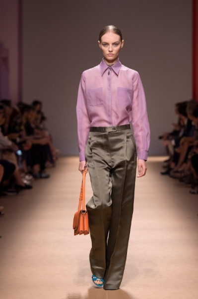 Salvatore Ferragamo's orange sling bag adds a dash of colour to strict formalwear Image