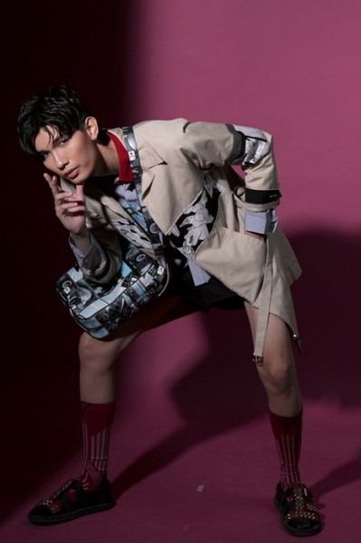 Printed trench coat and shirt, shorts, sandals with studs, socks and printed leather messenger bag, all by Prada Image