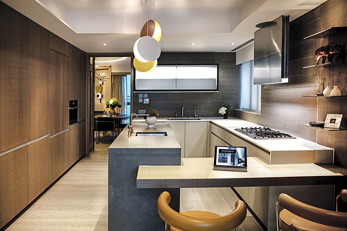 The kitchen area has a curvaceous, open and welcoming appeal