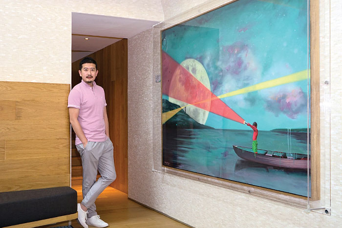 Wang Xiaobo posing with his art pieces, currently on display at The Repulse Bay Residence